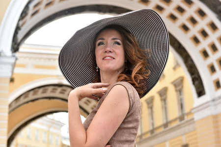 woman in wide-brimmed hat and dress summer portrait
