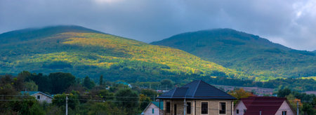 picturesque Crimean mountains covered with dense forest. Summer landscape turns into autumn, with...