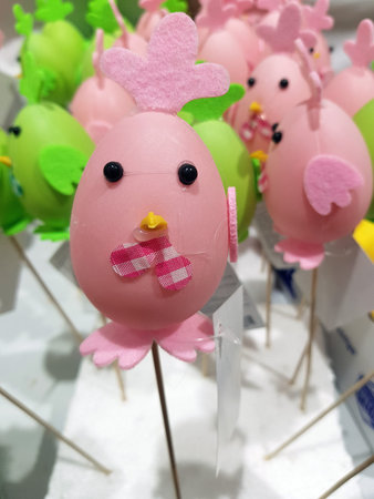 a bright decorative figurine in the form of a chicken, made in pink tones. The base is a soft pink...
