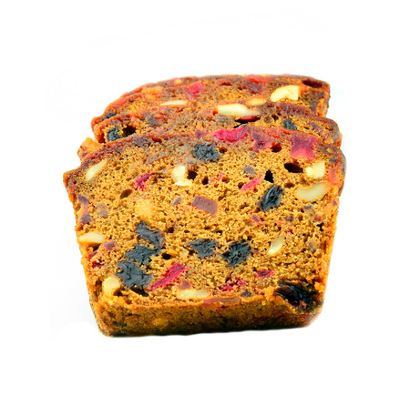 A traditional Christmas fruit cake isolated on a white の写真素材