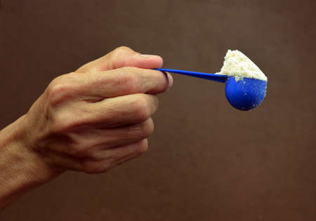 milk powder isolated on brown backgroundの写真素材