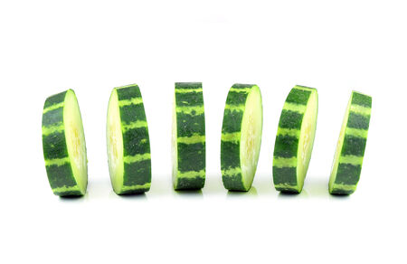 Cucumber and slices isolated over white backgroundの写真素材