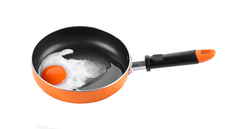 Eggs in small pan with plastic handle isolated on white backgroundの写真素材