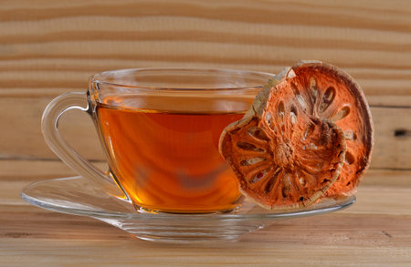 Dried quince and Quince water in glass on wooden table,