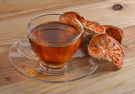 Dried quince and Quince water in glass on wooden table,