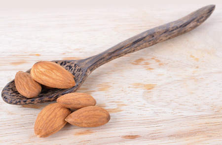 Almonds  on the wooden floorの写真素材