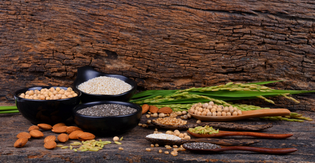 Cereal grains , seeds, beans on wooden background.の写真素材