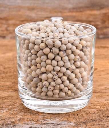 White pepper on wooden background.のeditorial素材