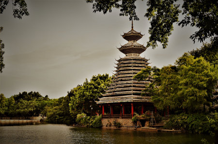 Traditional pagoda by a lake, in Shenzhenの写真素材