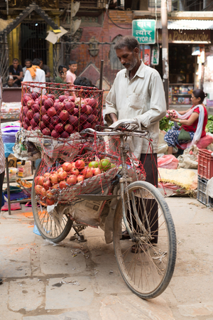 Street seller in Kathmandu selling apples from his bicycleのeditorial素材