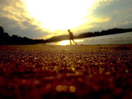 Silhouette of a person on the beachの写真素材