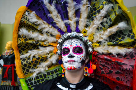 Mexico City, Mexico,; November 1 2015: Portrait of a woman with colorful hat or penacho in disguise at the Day of the Dead celebration in Mexico Cityのeditorial素材