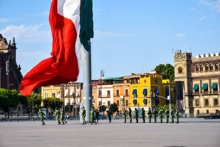Mexico City, Mexico; April 26 2020: flag ceremony in the mexico city z?calo square, lowering of the flag, backgroung Cathedralのeditorial素材