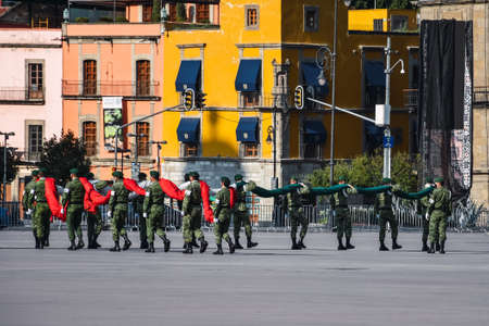 Mexico City, Mexico; April 26 2020: flag ceremony in the mexico city square, lowering of the flag, Soldiers in parade, backgroung Cathedralのeditorial素材