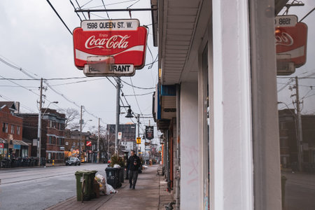 Toronto, ON Canada 12/27/19: Bright sign over quiet Parkdale sidewalk on Queen St.