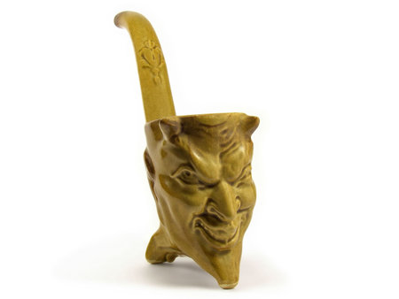 Ceramic cup made to look like a Devil's head isolated on white background.の写真素材