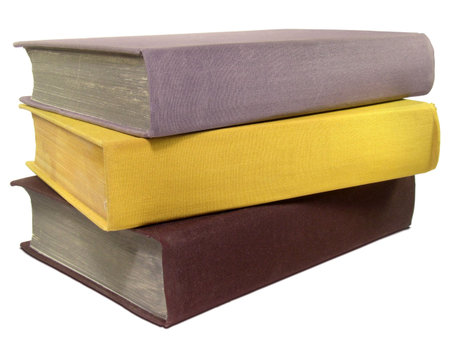 Stack of three old colorful books isolated on white background.の写真素材