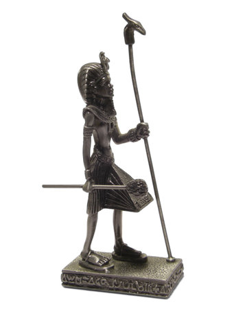 Metal statuette of Egyptian Pharaoh isolated on white background.の写真素材