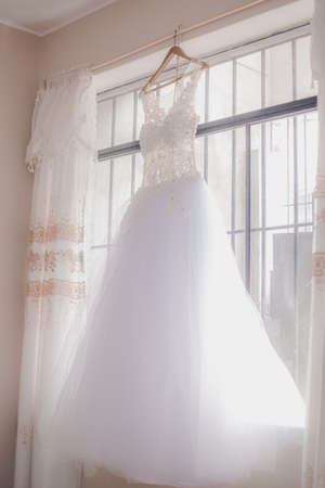 Wedding Dress Hanging in a Windowの写真素材