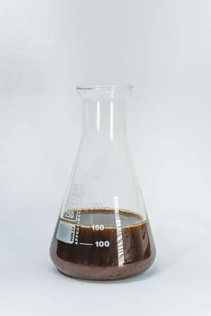 Chemical laboratory flask with brown chemicalsの写真素材
