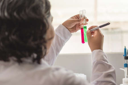 Young woman looking at a test tube in a laboratoryの写真素材