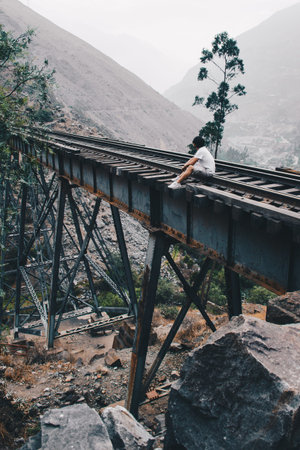 Man sitting in line of bridge train. panoramic and prespective vanishing point.