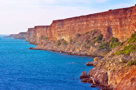 Coastal red rocks and blue Sea Landscape Summer Traveling headland Fiolent Cape near Sevastopol Crimea, Ukraineの写真素材