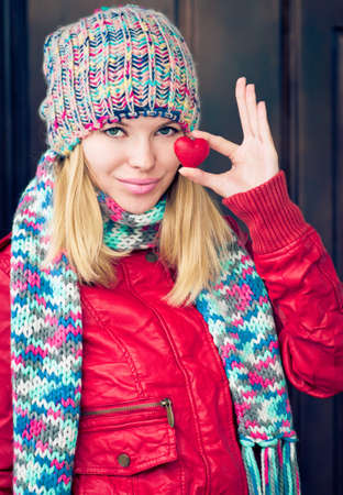 Woman Beautiful happy smiling Face hands holding Heart shape Love symbol greeting Valentines Day holiday winter season clothingの写真素材
