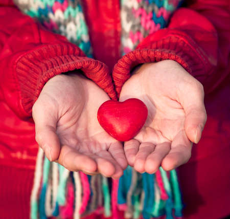 Heart shape love symbol in woman hands Valentines Day romantic greeting people relationship concept winter holidayの写真素材
