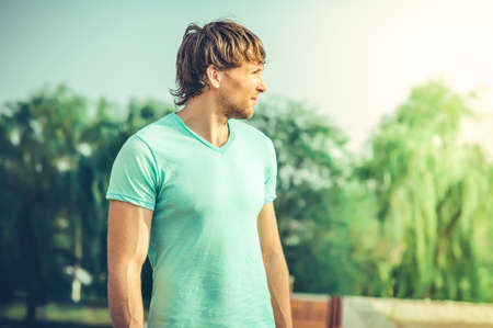 Man young handsome happy smiling face Outdoor with summer natureの写真素材