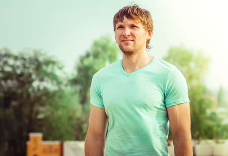 Man young handsome happy smiling face Outdoor with summer nature の写真素材