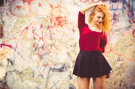 Young Woman model outdoor Urban Street Fashion Lifestyle trendy concept with old painted wall on backgroundの写真素材