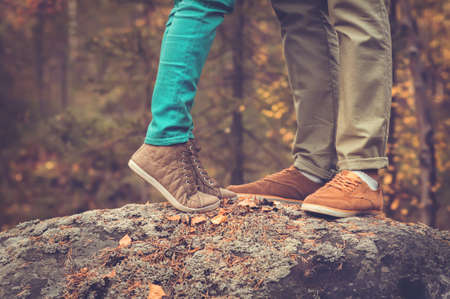 Couple Man and Woman Feet in Love Romantic Outdoor with Autumn season nature on background Fashion trendy styleの写真素材