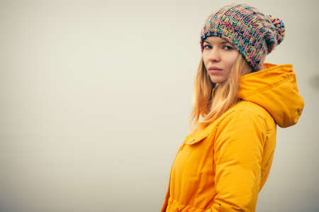 Young Woman wearing winter hat fashion clothing outdoor Travel Lifestyle and melancholy emotions concept foggy nature on backgroundの写真素材