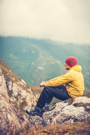 Man Traveler relaxing alone in Mountains Travel Lifestyle concept cloudy nature landscape on backgroundの写真素材