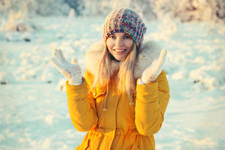 Young Woman Outdoor Winter Lifestyle happiness emotions in hat and mittens fashion clothing snow nature on backgroundの写真素材