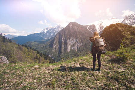 Woman Traveler with backpack hiking outdoor Travel Lifestyle concept mountains on background Summer journey vacationsの写真素材