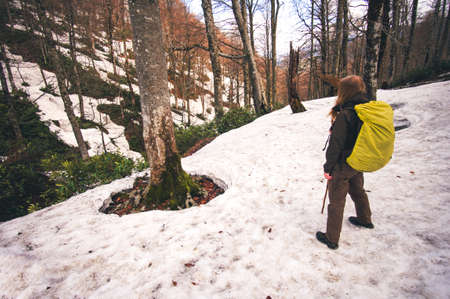 Woman Traveler with backpack hiking outdoor Travel Lifestyle concept forest on background journey vacationsの写真素材