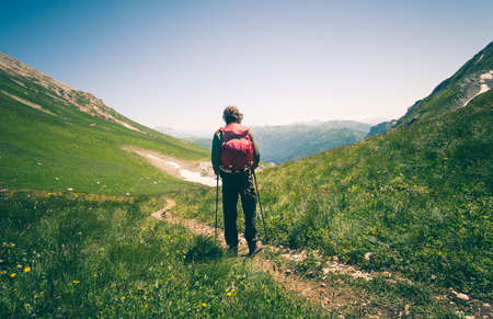 Man Traveler with backpack hiking outdoor Travel Lifestyle concept mountains on background Summer vacationsの写真素材
