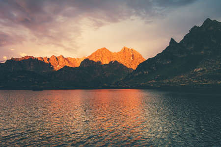 Sunset Landscape Rocky Mountains and Lake reflection with sky clouds Summer Travel serene viewの写真素材