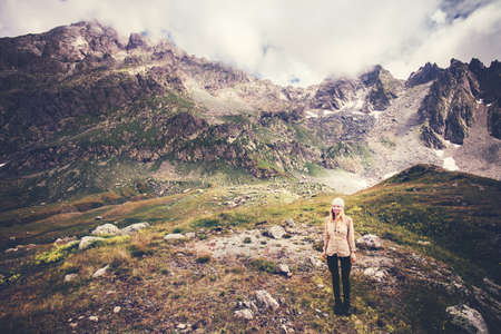 Woman Traveler mountaineering Travel Lifestyle concept Summer vacations outdoor rocky mountains on background moody weatherの写真素材