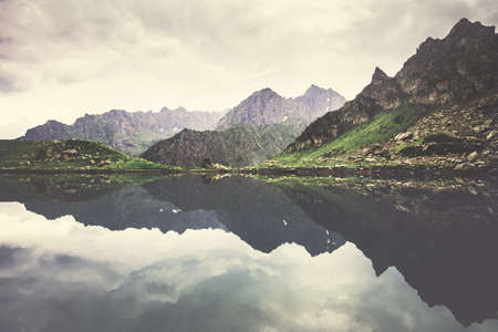 Landscape Rocky Mountains and Lake mirror reflection with moody sky clouds Summer Travel serene viewの写真素材