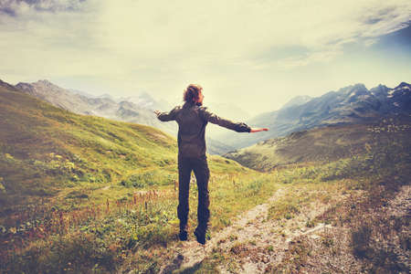 Traveler Man jumping with mountains landscape on background Lifestyle Travel happy emotions concept outdoorの写真素材
