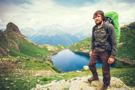 Bearded Man hiker with backpack mountaineering Travel Lifestyle concept lake and mountains on background Summer adventure vacations outdoorの写真素材