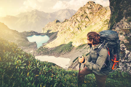Man Traveler with backpack mountaineering Travel Lifestyle concept lake and mountains landscape on background Summer vacations adventure outdoorの写真素材