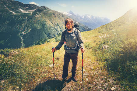 Traveler Man mountaineering with backpack Travel Lifestyle wellness concept mountains on background Summer adventure vacations outdoorの写真素材