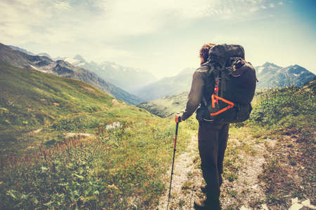 Traveler Man with backpack mountaineering Travel Lifestyle concept mountains and clouds on background Summer adventure vacations outdoorの写真素材