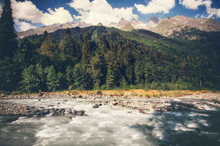 Mountains River and forest Landscape with blue sky clouds beautiful scenic view wild nature summer travel in Abkhaziaの写真素材