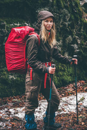 Woman Hiker with red backpack traveling Lifestyle adventure survival concept outdoor rainy moody weatherの写真素材
