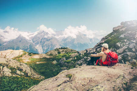 Woman Traveler with backpack relaxing with mountains serenity view Travel Lifestyle concept hiking adventure summer vacations の写真素材